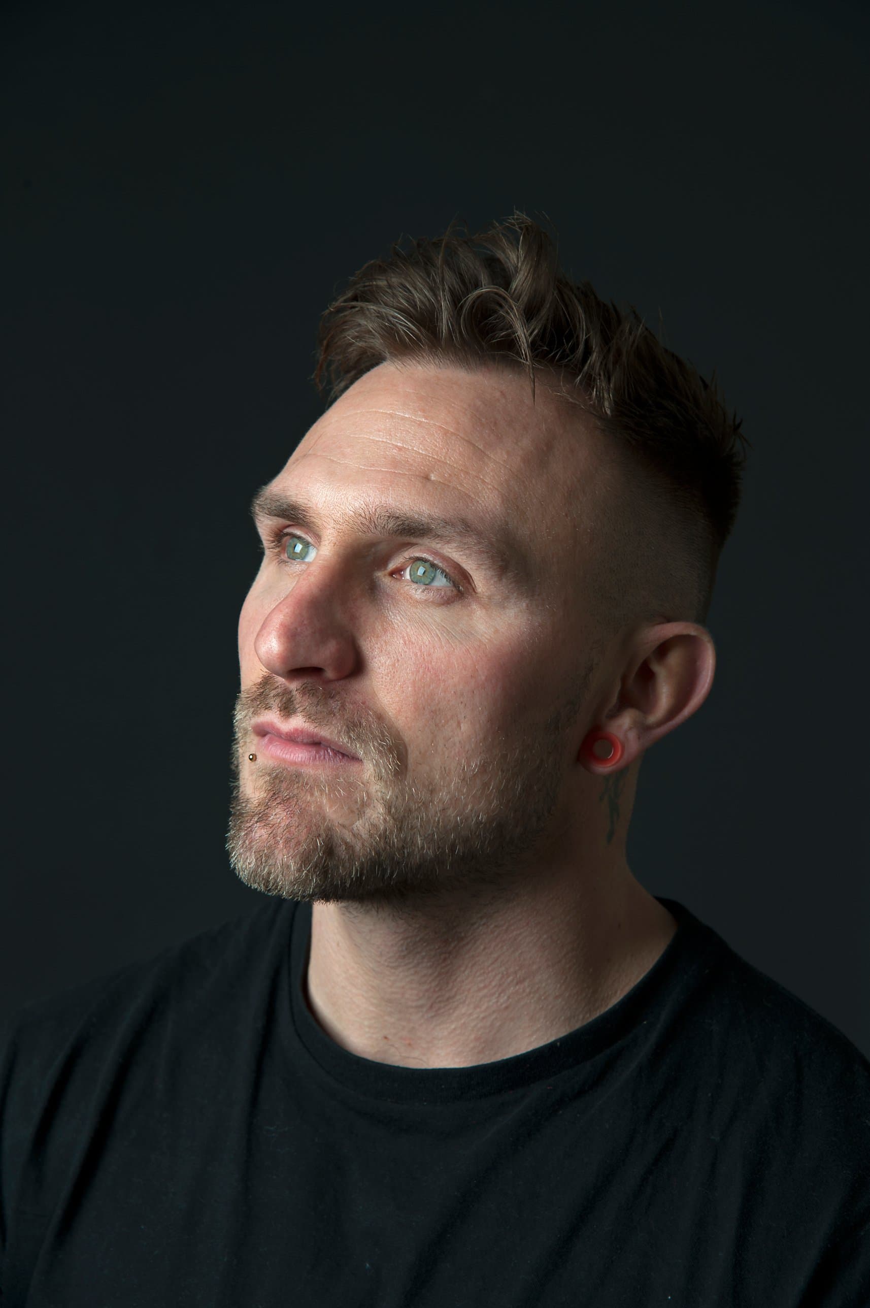 Portrait of Lee Coulson against a dark background